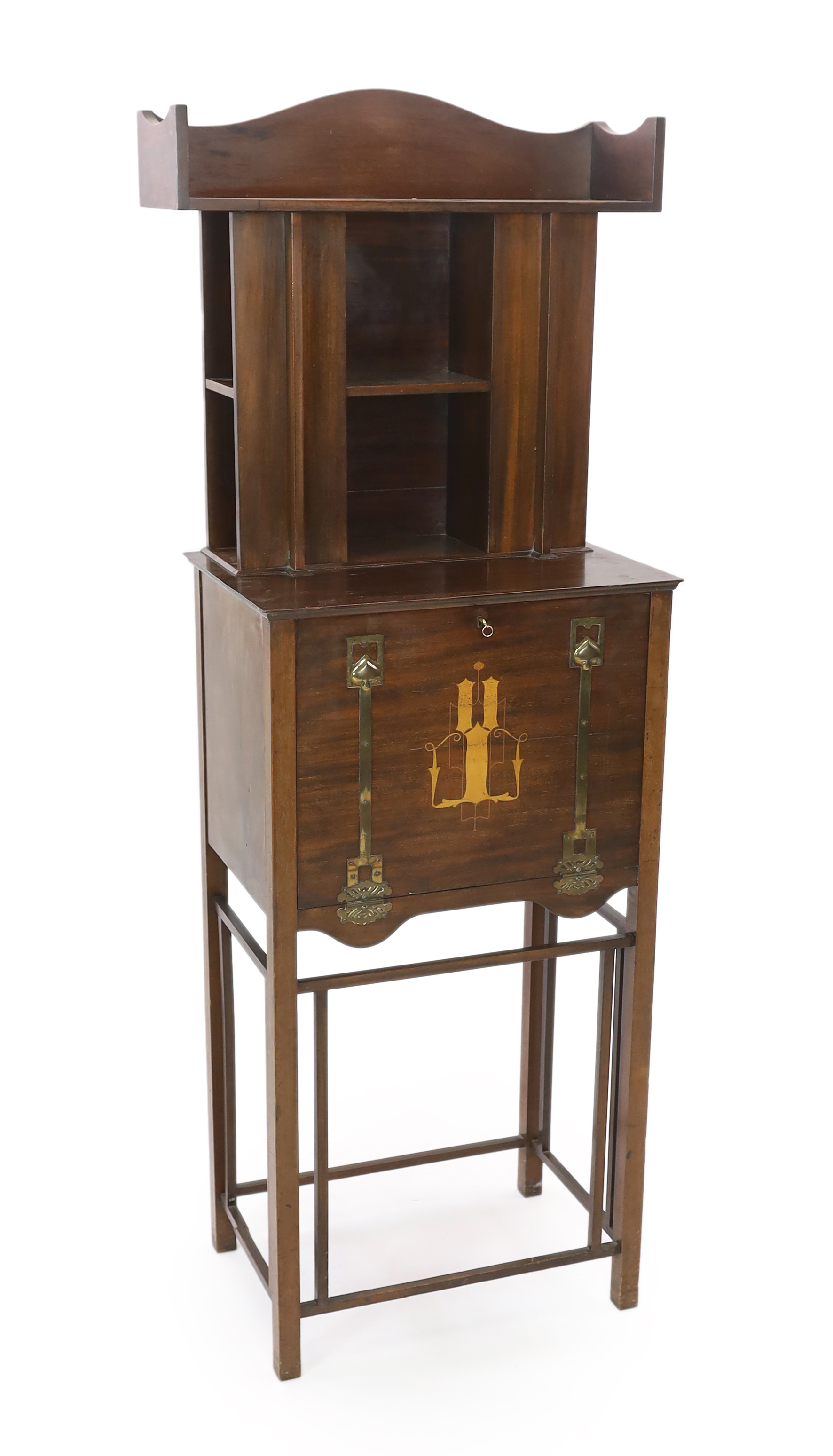 An early 20th century Arts & Crafts inlaid mahogany music cabinet, made by George Montague Ellwood and retailed by J.S. Henry of London